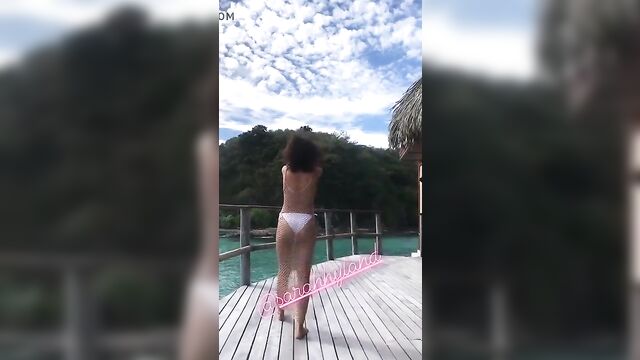 Sarah Hyland in a white bikini on vacation