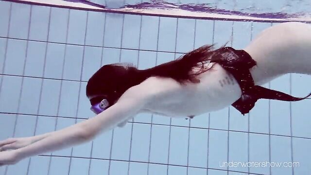 Roxalana Cheh floating naked alone in the pool