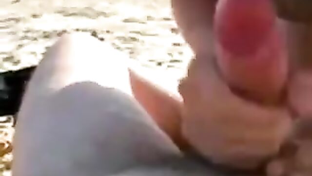Mistress blowing at public beach in see through bra