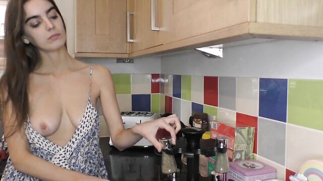 Hot brunette in the kitchen working and showing boobs