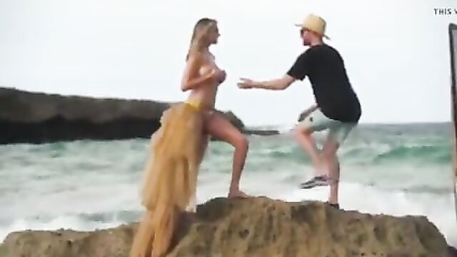 Kate Upton on the beach, washed of rock while topless