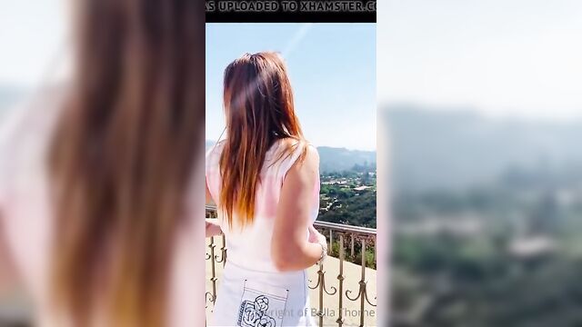 Bella Thorne taking on a balcony taking her top off