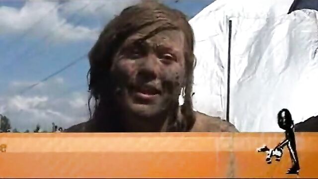 Topless Danish girl covered in mud at Roskilde Festival