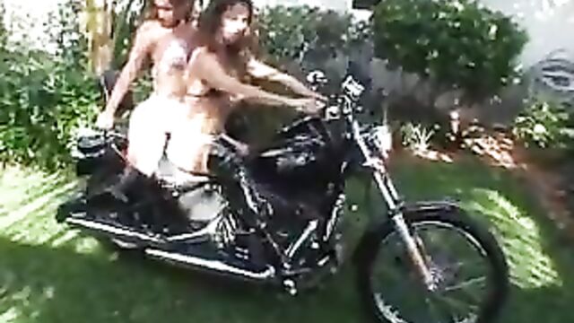 2 girls revving motorcycle in boots