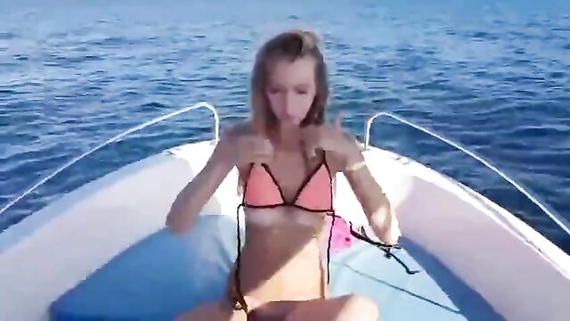 girl is sailing a yacht and make striptease