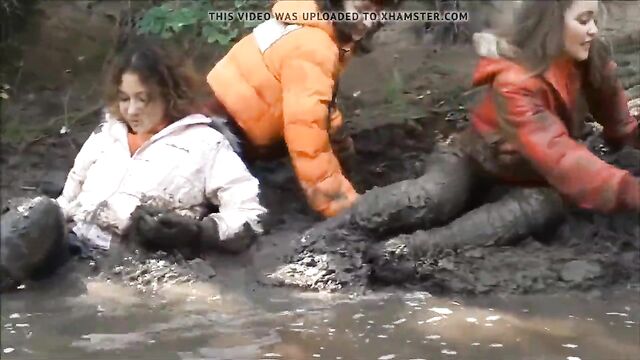 Three Girls in Mud in Winter Clothes