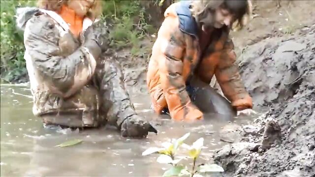 Three Girls in Mud in Winter Clothes