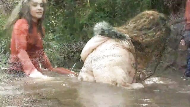 Three Girls in Mud in Winter Clothes