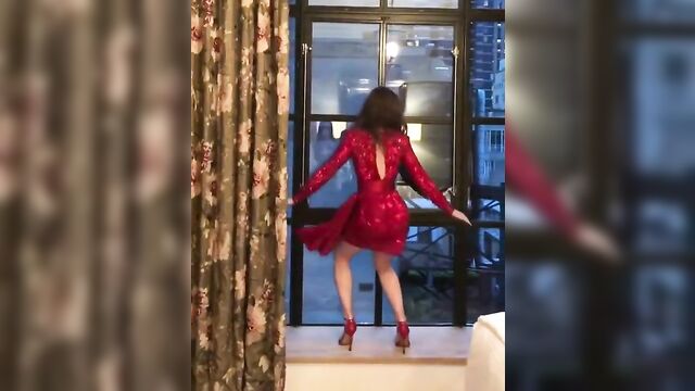 Lily Collins dancing in red dress and high heels