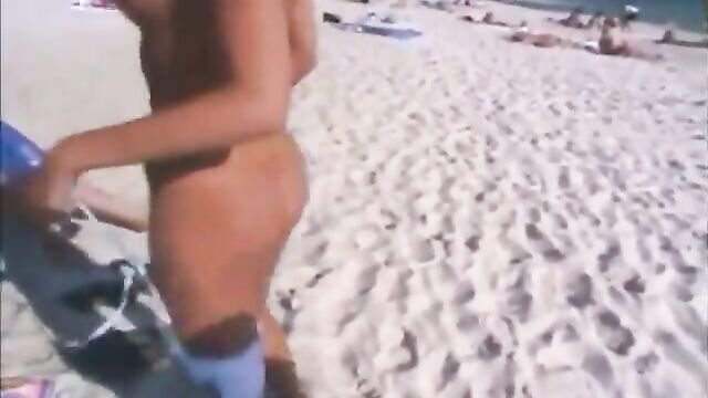 Girl gets naked in front of friends on a beach