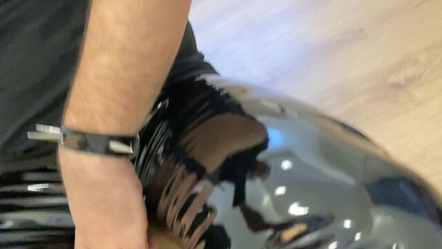 Guy in shiny pvc pants and gloss boots