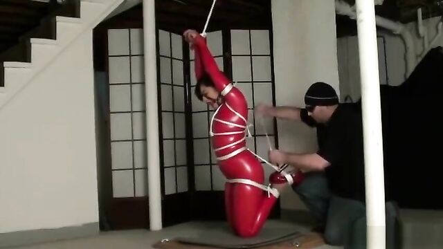Bondage in straigh latex catsuit and ball gag