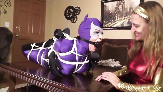 Cat woman in bondage on table