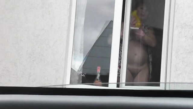 Naked Milf washes window, taxi driver spying from car, public