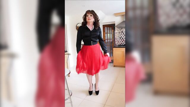 Sindy swishes her red pleated skirt