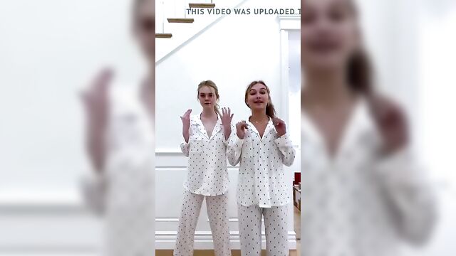 Elle Fanning and a blonde friend dancing in their pajamas