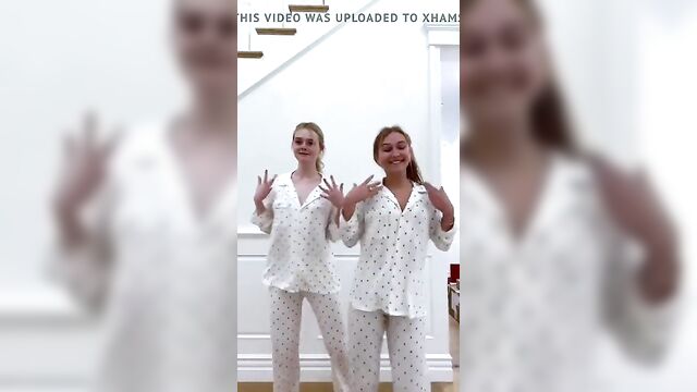 Elle Fanning and a blonde friend dancing in their pajamas