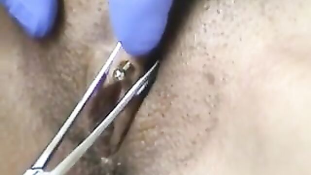 Horizontal clit hood piercing