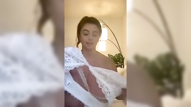 Huge natural tits trying on a bikini top