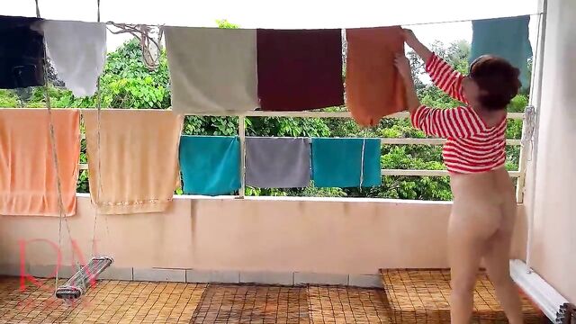 Naked laundry. The maid is drying clothes in the laundry.