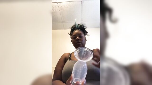 Busty Ebony squeezes milk out of giant tits