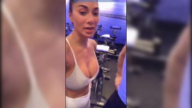 Nicole Scherzinger in gym showing big cleavage in white top