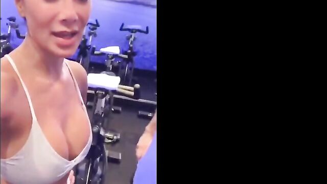 Nicole Scherzinger in gym showing big cleavage in white top