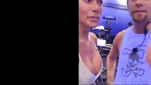 Nicole Scherzinger in gym showing big cleavage in white top