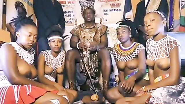 African chief with his own topless girls