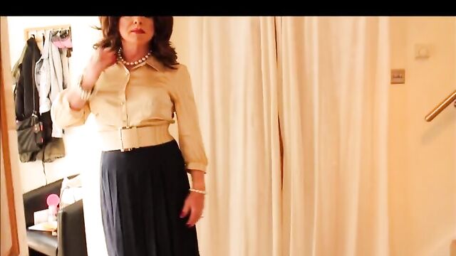 Gold blouse and blue pleated skirt