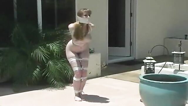 Tied naked girl hops outside