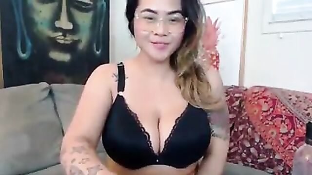 Busty Asian camgirl fondles her huge pierced boobs