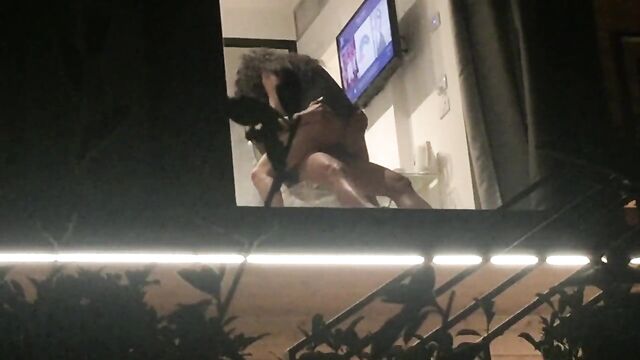 Voyeur caught horny couple fucking through hotel window