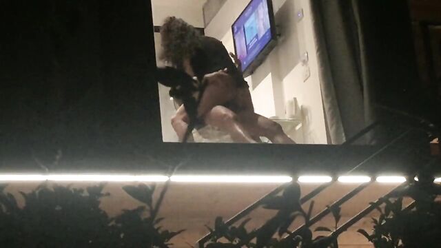 Voyeur caught horny couple fucking through hotel window