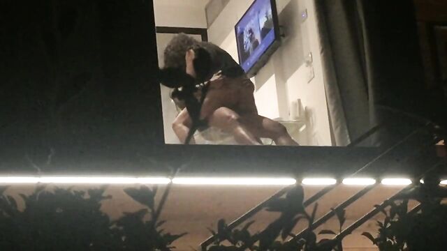 Voyeur caught horny couple fucking through hotel window