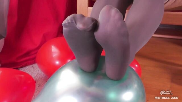 Mistress In Grey Opaque Pantyhose And High Heels Plays With Balloons