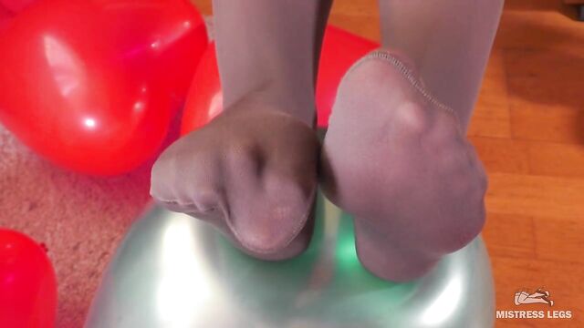 Mistress In Grey Opaque Pantyhose And High Heels Plays With Balloons
