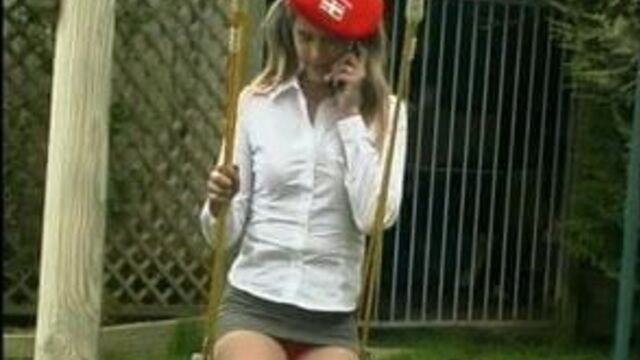 Teen in extreme mini skirt outdoor on a swing
