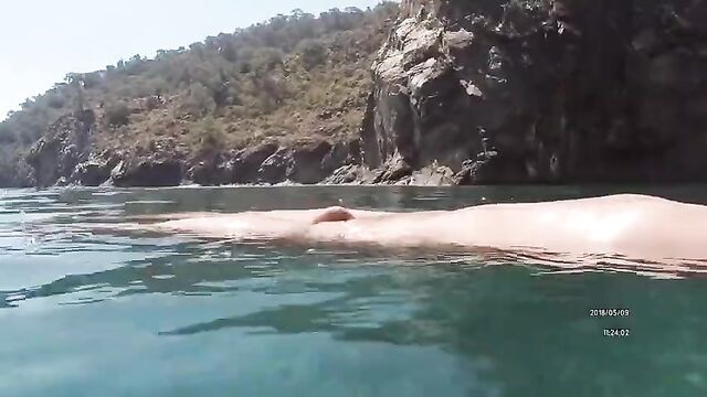 Swimming naked in the sea. Very erotic.