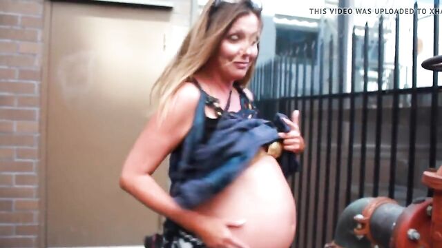pregnant street-Showing off the belly in a bikini top