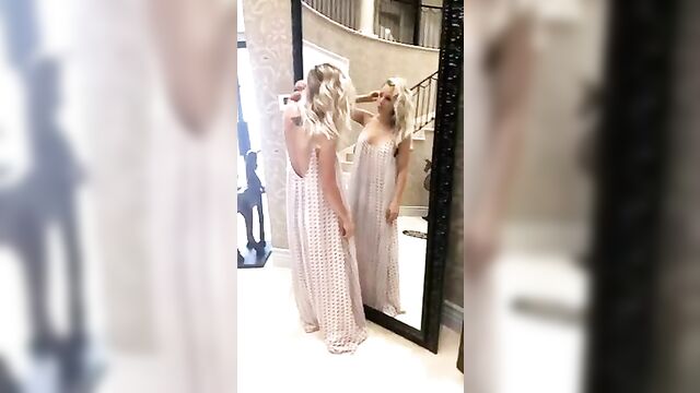 Kaley Cuoco checking herself in a mirror