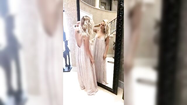 Kaley Cuoco checking herself in a mirror