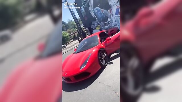 Saxon Sharbino posing in a red car