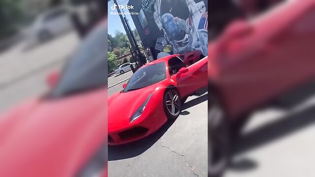 Saxon Sharbino posing in a red car