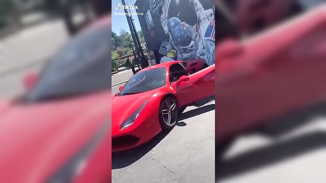 Saxon Sharbino posing in a red car