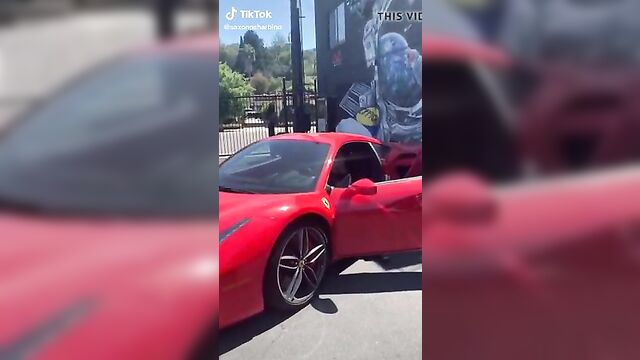 Saxon Sharbino posing in a red car