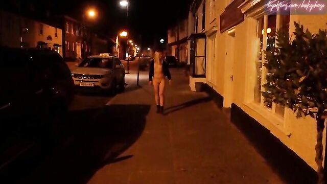 Young blonde wife walking nude down a high street in Suffolk