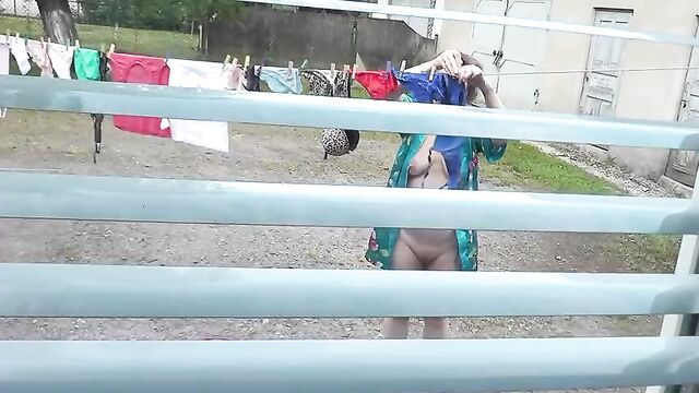 Naked in public. Neighbor saw pregnant neighbor in window who was drying clothes in yard without bra and panties. Nudist