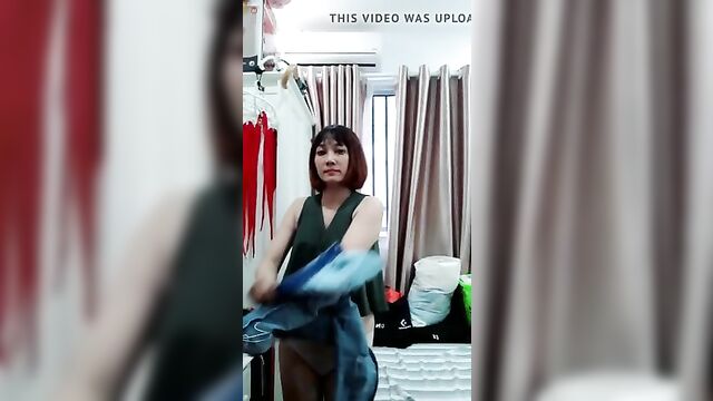 Vietnamese girl finishing getting dressed