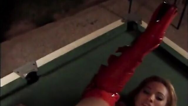 Babe in red boots is on top of a pool table sucking a cock